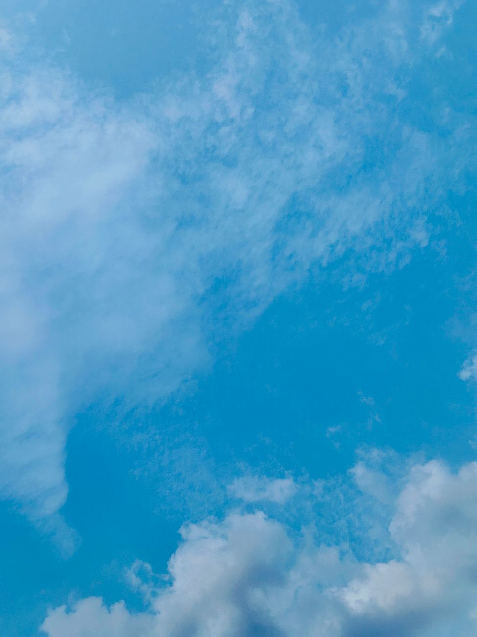 clear blue sky with fluffy clouds