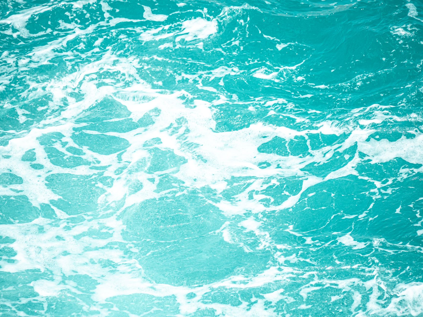 vibrant turquoise ocean waves with white foam
