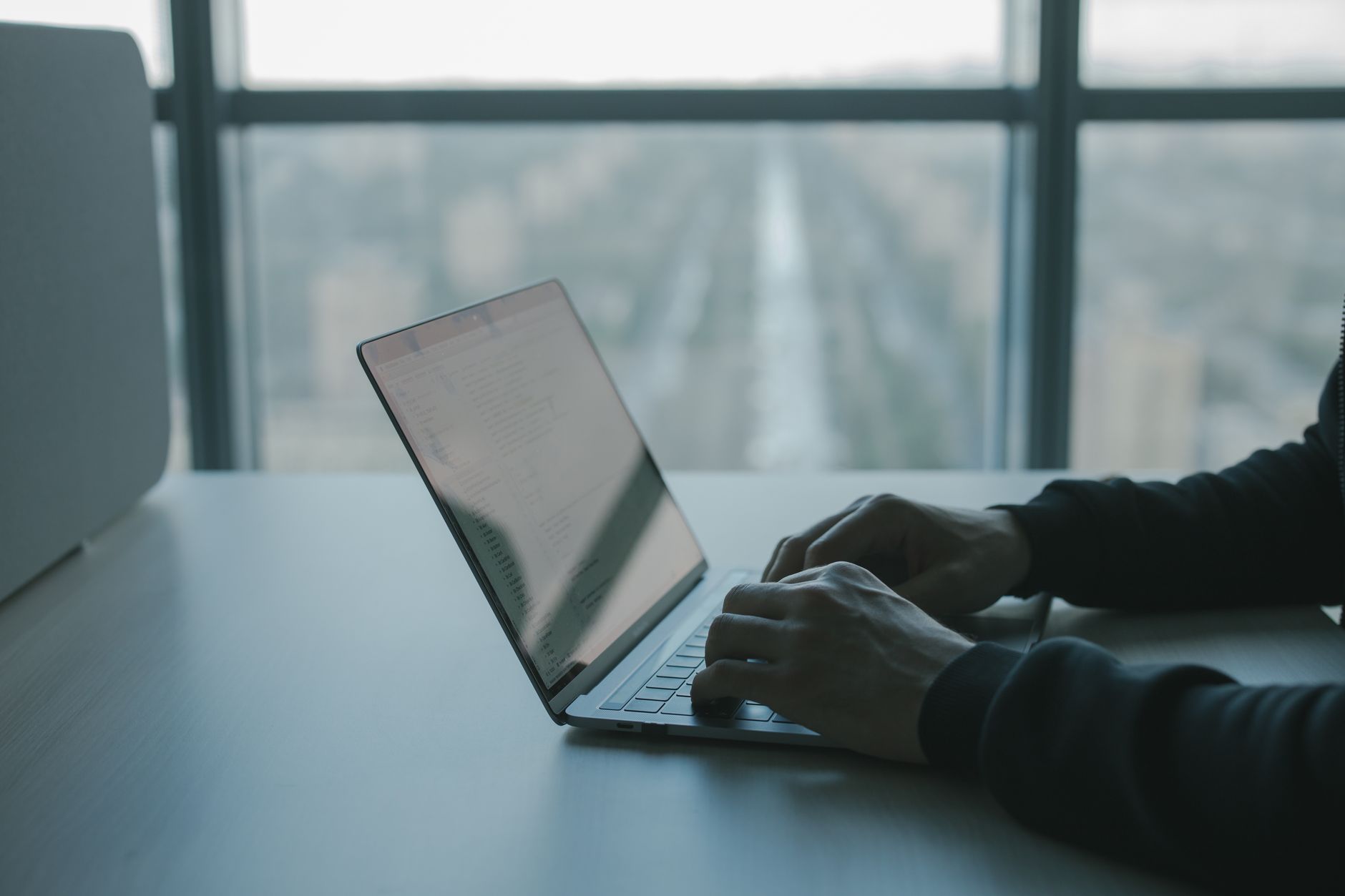 person using macbook on table